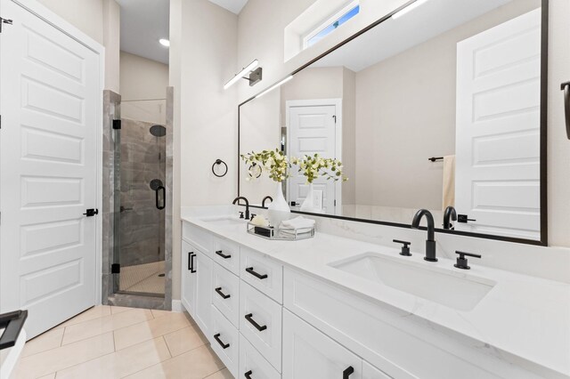 4013 Griggs Rd Unit L, Houston, TX 77021 - bathroom with double vanity, a shower stall, a sink, and tile patterned flooring