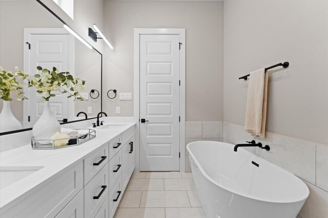 4013 Griggs Rd Unit L, Houston, TX 77021 - full bath featuring double vanity, a soaking tub, tile patterned floors, and a sink