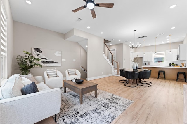 4013 Griggs Rd Unit L, Houston, TX 77021 - living area with light wood-type flooring, recessed lighting, ceiling fan with notable chandelier, and stairway