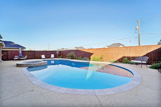 view of swimming pool with an in ground hot tub and a patio