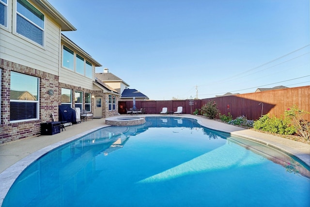 view of swimming pool featuring an in ground hot tub and a patio