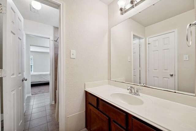 bathroom with tile patterned flooring and vanity