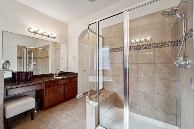 bathroom featuring vanity, an enclosed shower, and tile patterned flooring