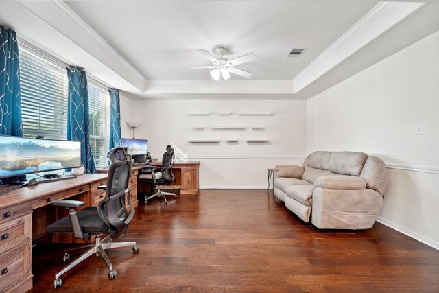 office space with crown molding, ceiling fan, dark hardwood / wood-style flooring, and a tray ceiling