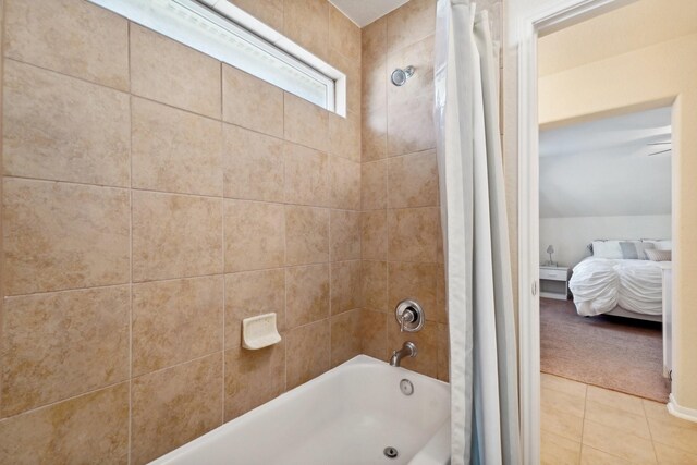 bathroom featuring tile patterned floors and shower / bath combo with shower curtain