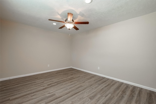 spare room featuring ceiling fan, hardwood / wood-style floors, and a textured ceiling