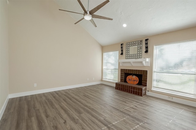 unfurnished living room featuring a healthy amount of sunlight, a fireplace, and light hardwood / wood-style floors