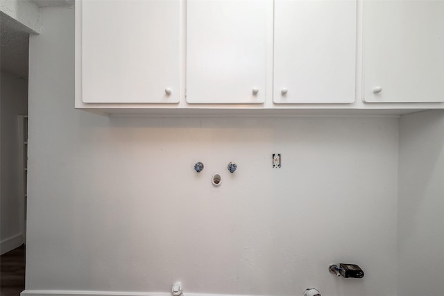 clothes washing area with cabinets and hookup for a gas dryer