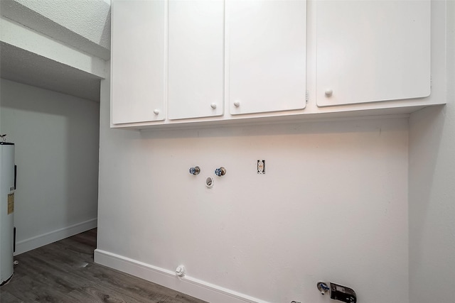 laundry area with gas dryer hookup, cabinets, dark hardwood / wood-style flooring, and water heater