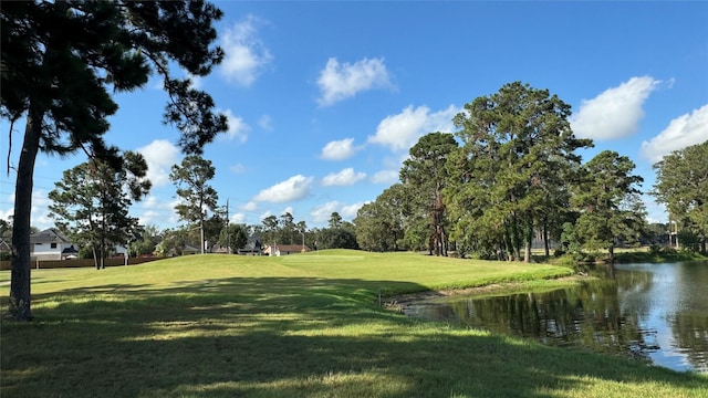 surrounding community featuring a water view and a lawn