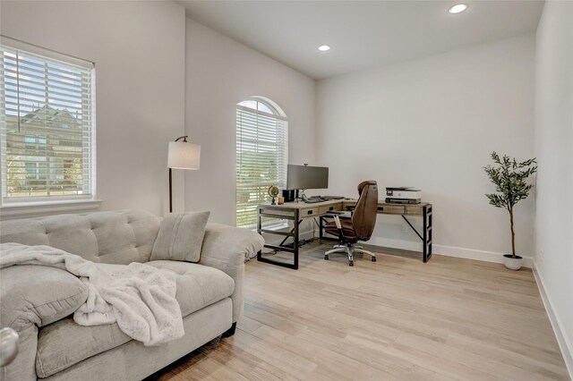 office space featuring recessed lighting, light wood-style flooring, and baseboards