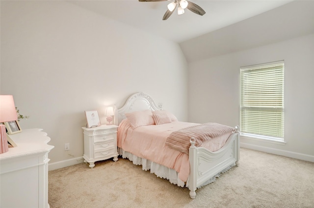 bedroom with light carpet, vaulted ceiling, a ceiling fan, and baseboards