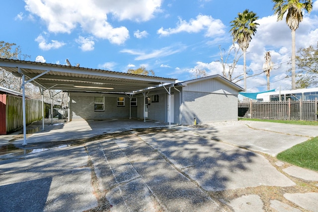 rear view of property with a carport