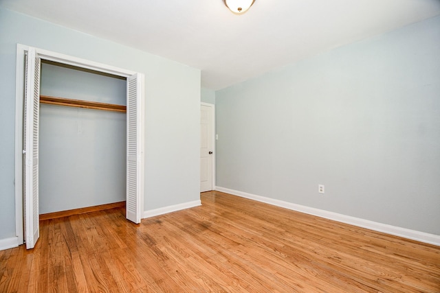 unfurnished bedroom featuring a closet and light hardwood / wood-style flooring