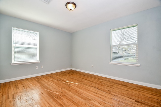 unfurnished room with light hardwood / wood-style flooring