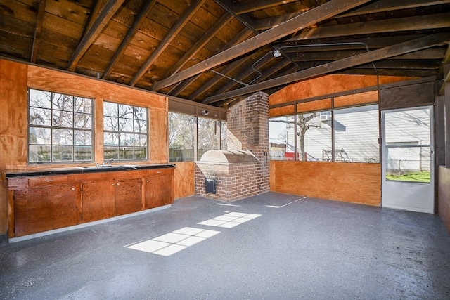 unfurnished sunroom with vaulted ceiling, sink, and wooden ceiling