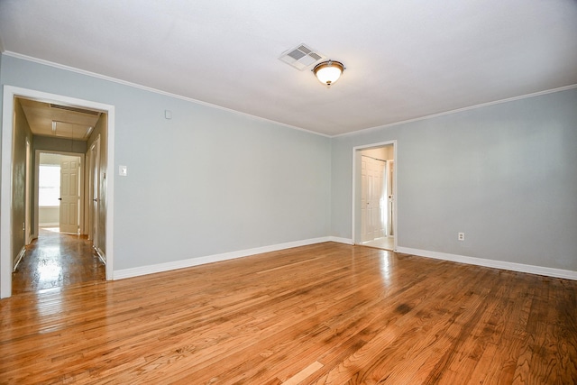 empty room featuring crown molding and light hardwood / wood-style flooring