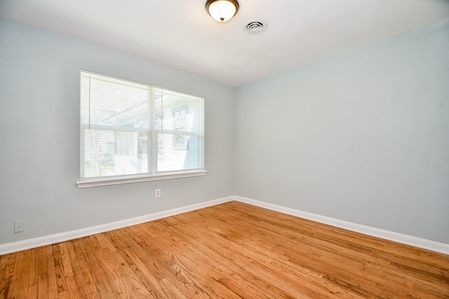 empty room with light hardwood / wood-style flooring