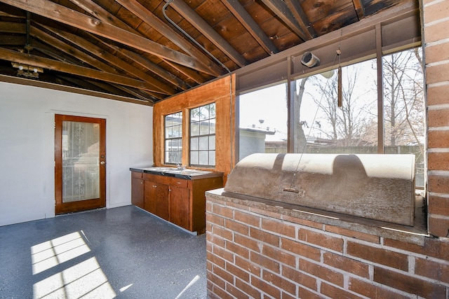 sunroom / solarium featuring vaulted ceiling