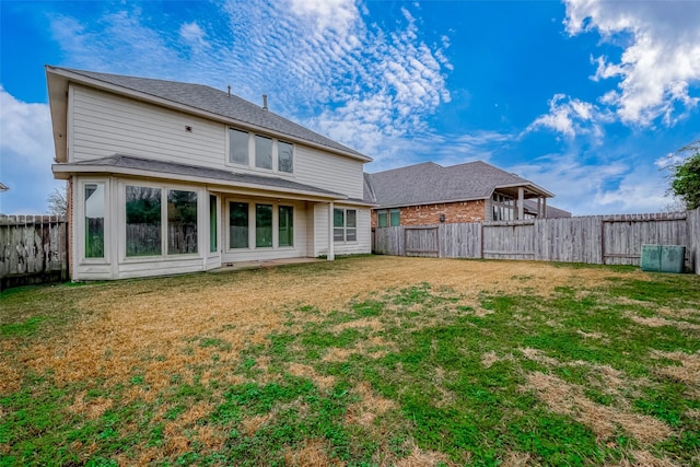 rear view of house with a yard