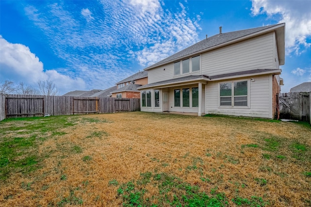 rear view of house with a lawn