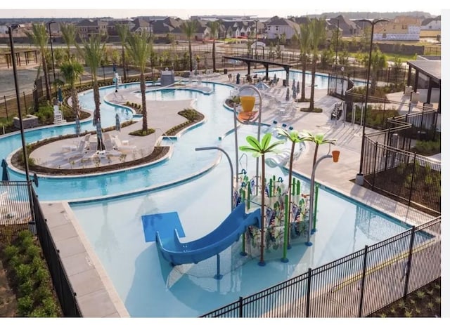 view of pool featuring a patio area and a water slide