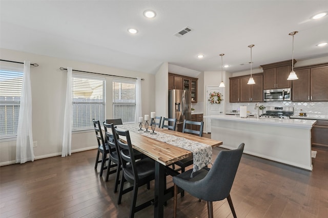 dining area featuring dark hardwood / wood-style flooring and sink