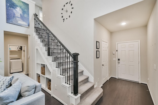 entryway with washer / dryer and dark wood-type flooring