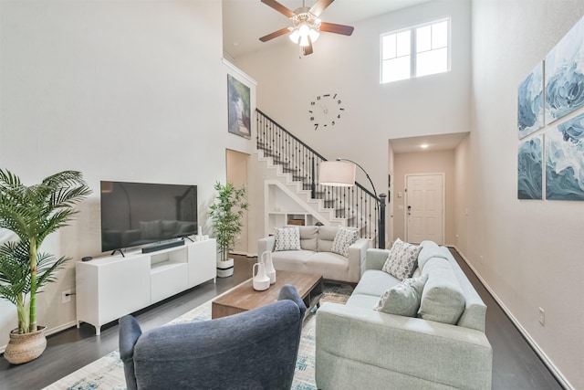 living room with ceiling fan and dark hardwood / wood-style flooring