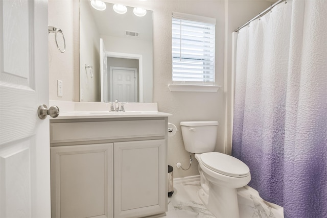 bathroom featuring vanity and toilet