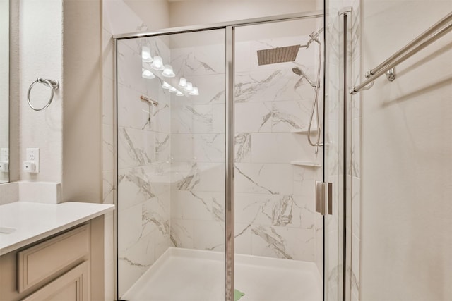 bathroom featuring vanity and a shower with shower door