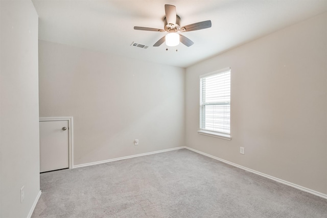 unfurnished room with ceiling fan and light carpet