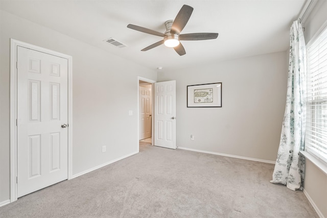 unfurnished bedroom featuring ceiling fan and light colored carpet