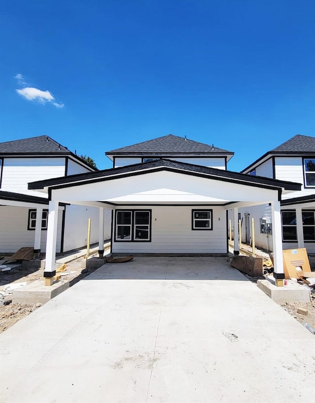 rear view of property with a carport