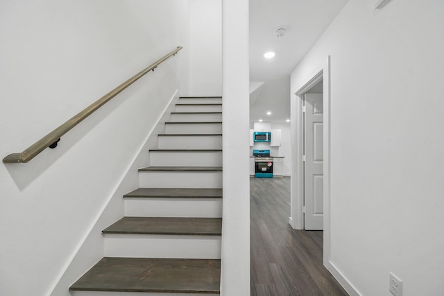 staircase with hardwood / wood-style flooring