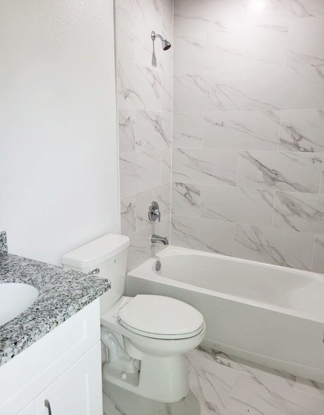 full bathroom with vanity, tiled shower / bath combo, and toilet