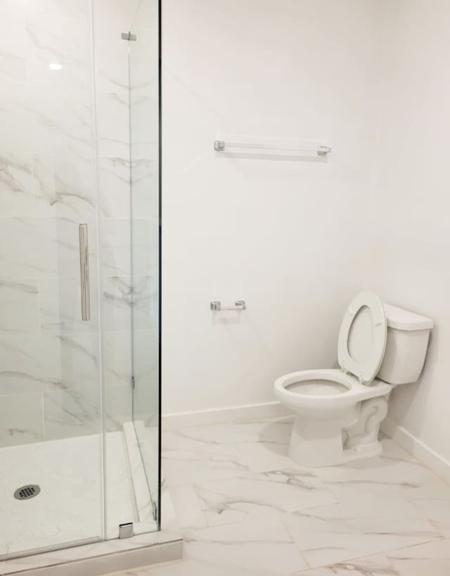 bathroom with toilet and an enclosed shower