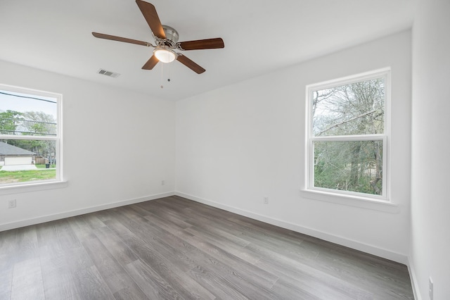 spare room with ceiling fan and wood-type flooring