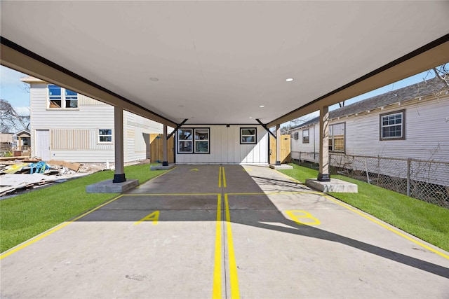 exterior space with fence, board and batten siding, and a front yard