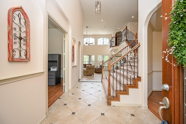 entryway featuring a towering ceiling