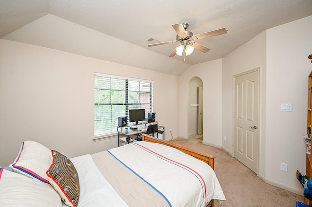 bedroom featuring ceiling fan, lofted ceiling, and light carpet