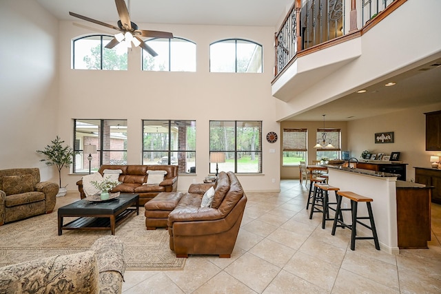 living room featuring light tile patterned flooring and ceiling fan