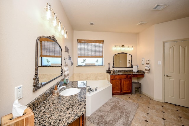 bathroom featuring vanity, tile patterned flooring, and a bathing tub