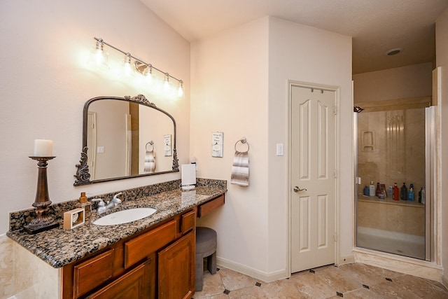 bathroom with vanity and a shower with door