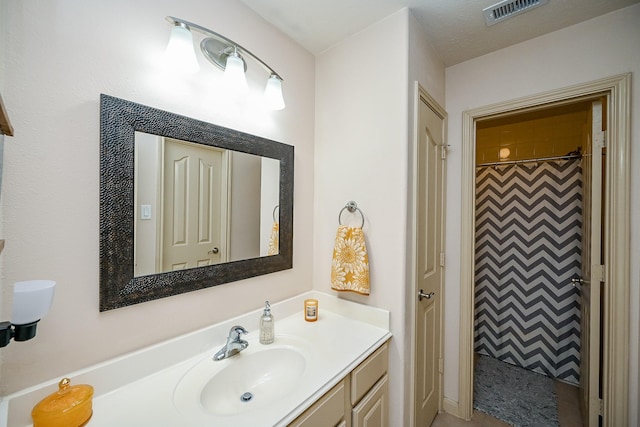 bathroom featuring vanity and a shower with shower curtain