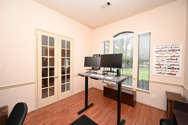 home office with crown molding, light hardwood / wood-style flooring, and french doors