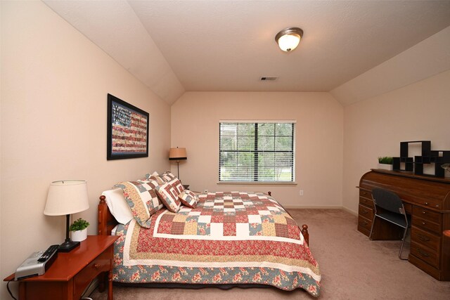 carpeted bedroom with lofted ceiling