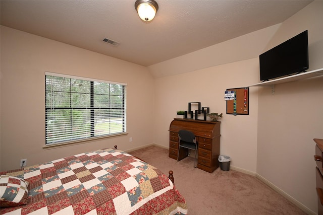 carpeted bedroom with lofted ceiling