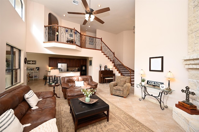 living room featuring a high ceiling and ceiling fan