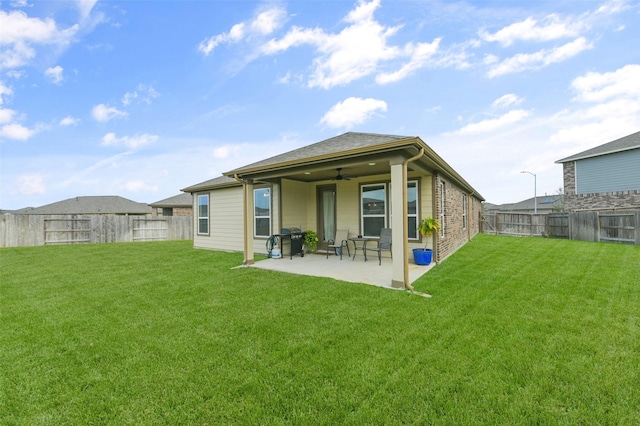 back of house featuring a yard, a patio, and ceiling fan